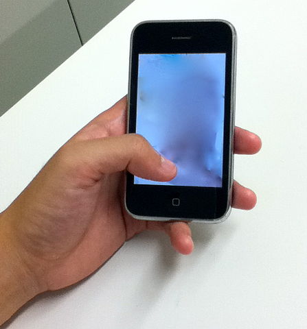 Photo of a phone with a blurred image on the screen