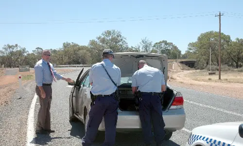 Vehicle that was stopped by police being searched for illegal drugs